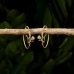 Ruvari Pushpavalli Hoops – Elegant Gold & Diamond Floral Hoop Earrings with Emerald Accents